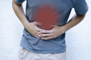 man-with-stomach-pain-holding-his-belly-gastrointestinal-disorders