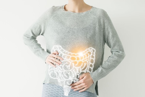 Intestine visualisation on woman body she is holding stomach
